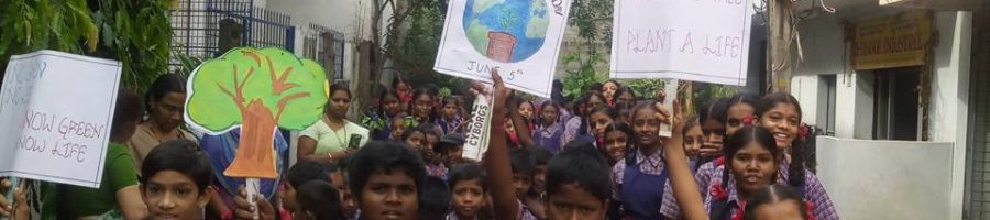 A group of children holding colorful posters in their hands, celebrating Eco Day, smiling and showing enthusiasm for environmental awareness.